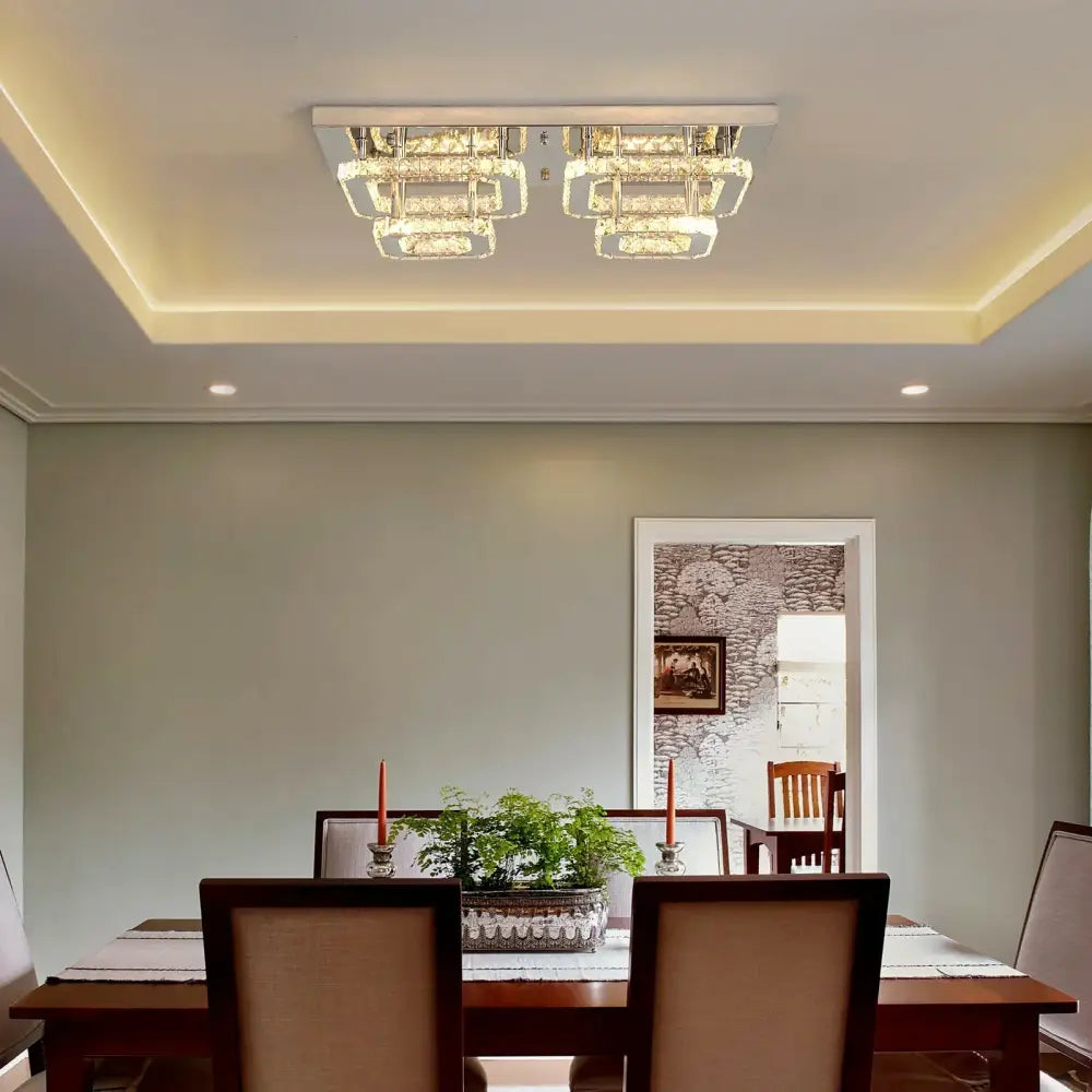Modern silver crystal ceiling chandelier with sleek chrome frame and layered illuminated glass panels for living room lighting