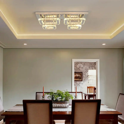 Modern silver crystal ceiling chandelier with sleek chrome frame and layered illuminated glass panels for living room lighting
