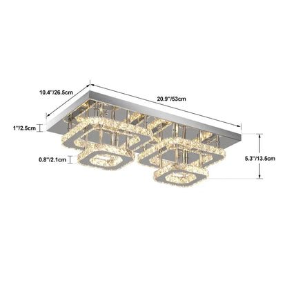 Modern silver crystal ceiling chandelier with sleek chrome finish and layered crystal rings emitting warm light