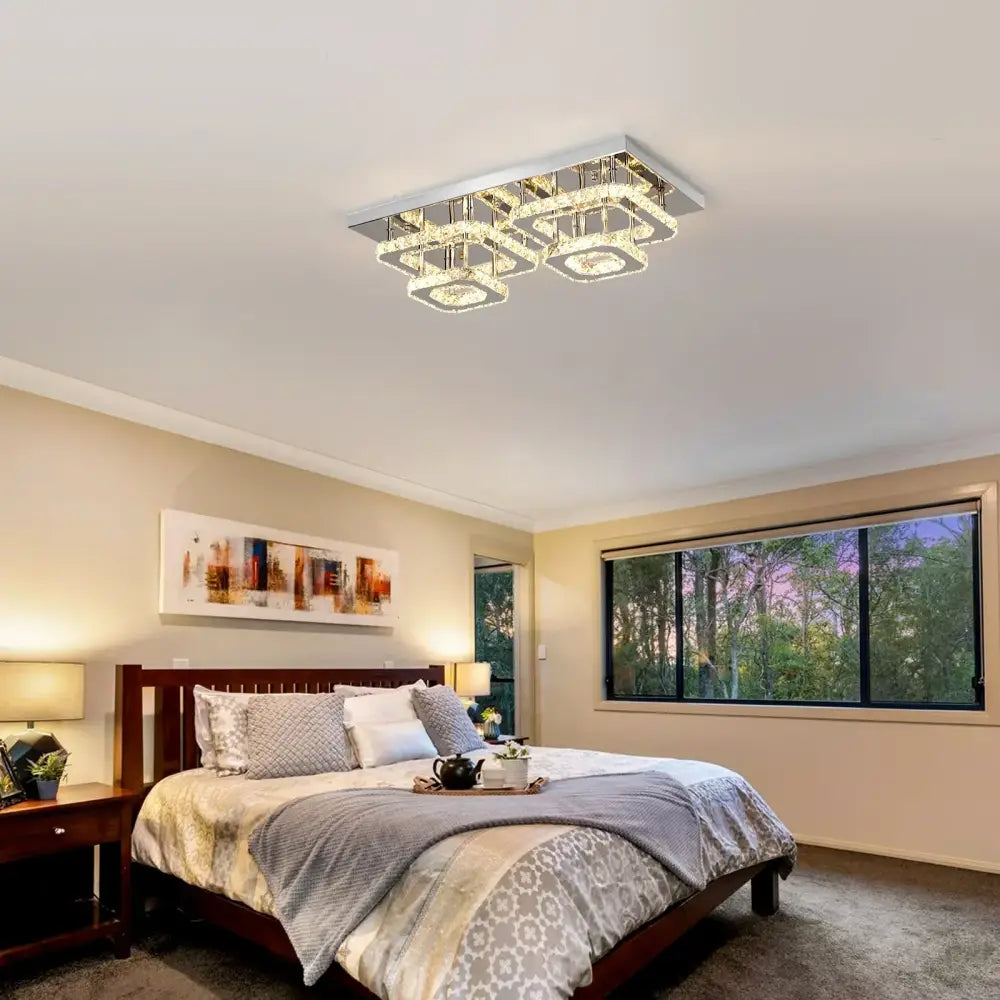 Modern silver crystal ceiling chandelier with a sleek chrome frame and multiple tiers of clear crystal accents