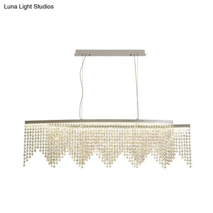 Modern silver crystal island pendant chandelier with sleek metal frame and cascading clear crystal beads for dining room