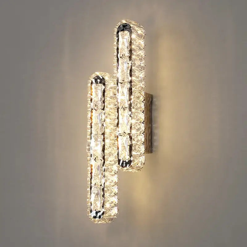 Modern silver crystal led wall lamp featuring two vertical staggered bars of clear faceted crystals in sleek frame