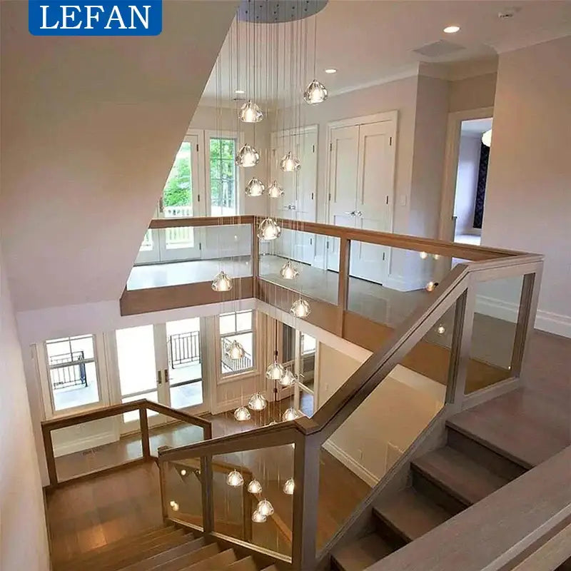 Modern silver crystal pendant light with glass bubble chandelier and cord pendant installation above staircase