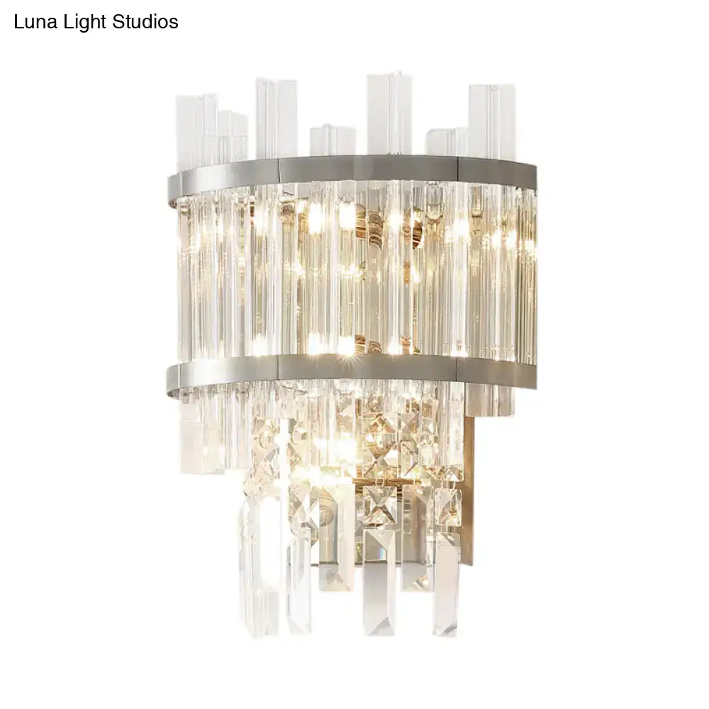 Modern silver wall mounted fixture with clear crystal tiers and silver metal bands for dining room wall light