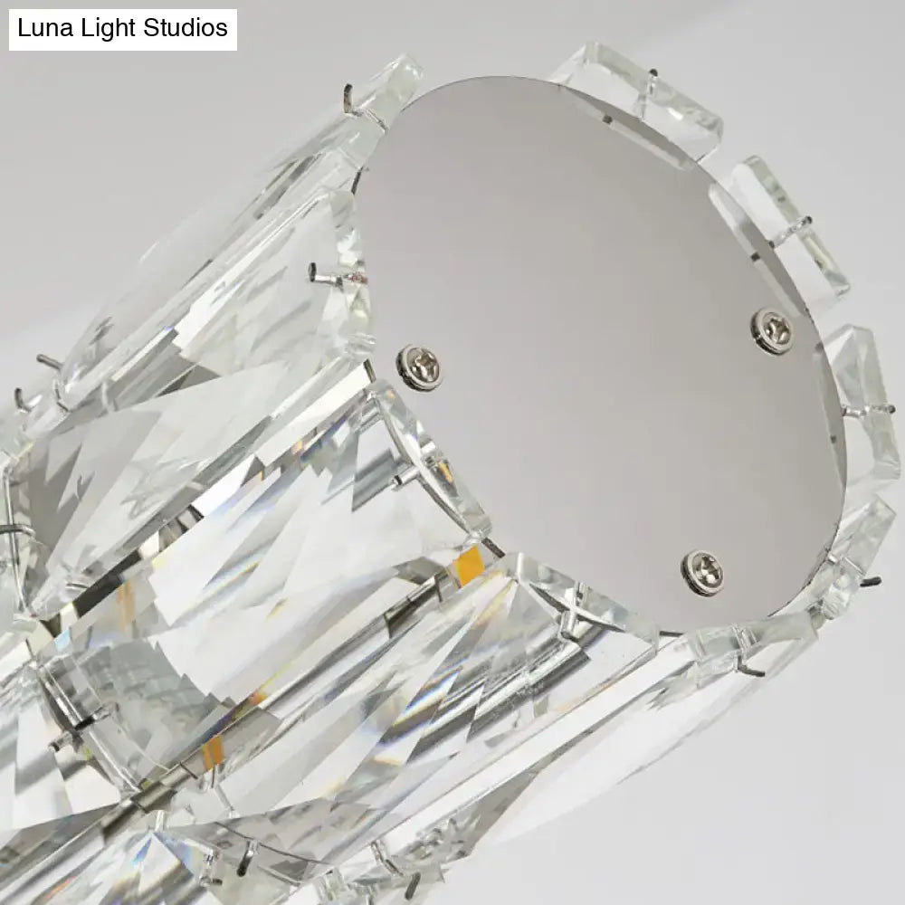 Modern silver crystal tube island light featuring faceted clear glass elements and sleek metal base for dining room use