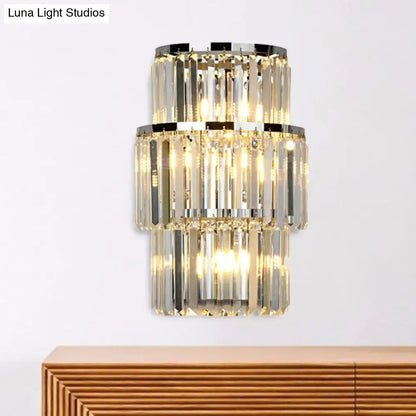 Modern silver crystal three-tiered wall mounted light with faceted clear glass rods and polished chrome accents