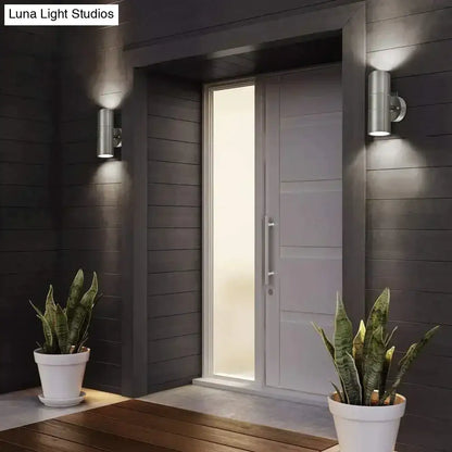 Modern silver cylindrical wall sconces made of metal with a sleek minimalist design for outdoor lighting