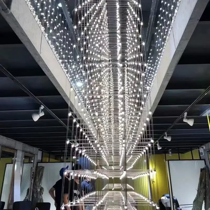 A dazzling white led decorbites cosmos chandelier with a grid of bulbs creating a starry effect for dining rooms