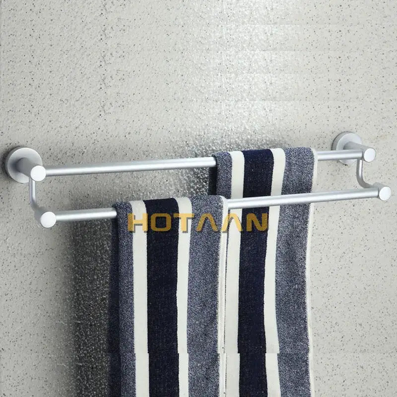 Modern silver double towel bar bathroom rack holding navy and white striped towels for organized towel storage