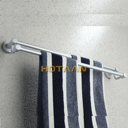 Modern silver double towel bar bathroom rack holding a navy and white striped towel on a silver double towel bar