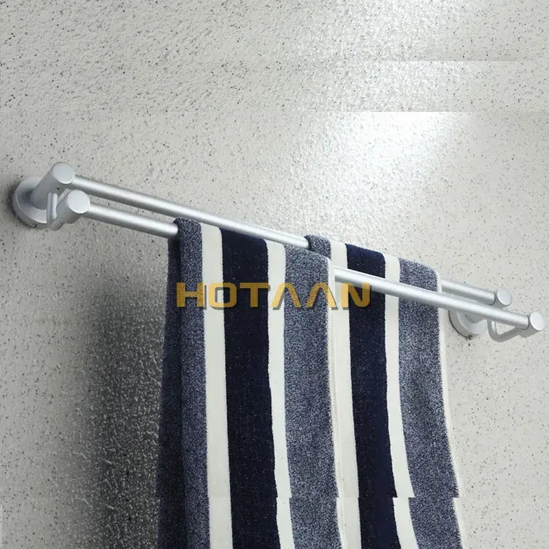 Modern silver double towel bar bathroom rack holding a navy and white striped towel on a silver double towel bar