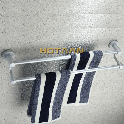 Modern silver double towel bar made of metal holding navy and white striped towels for bathroom use