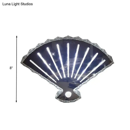 Modern silver fan wall lamp with scalloped led light features shiny silver shell design and glowing white vertical strips