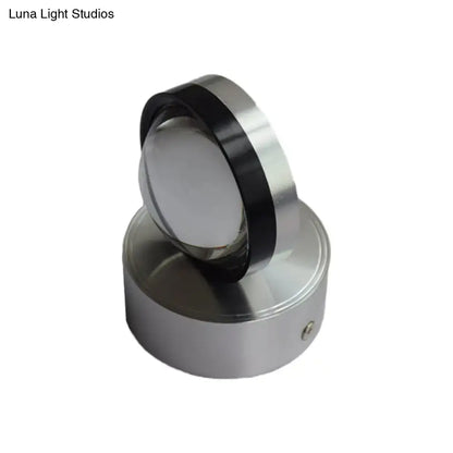Silver finish cylindrical wall-mounted light fixture with polished metallic finish and black accent ring for bedroom wall warm white lighting