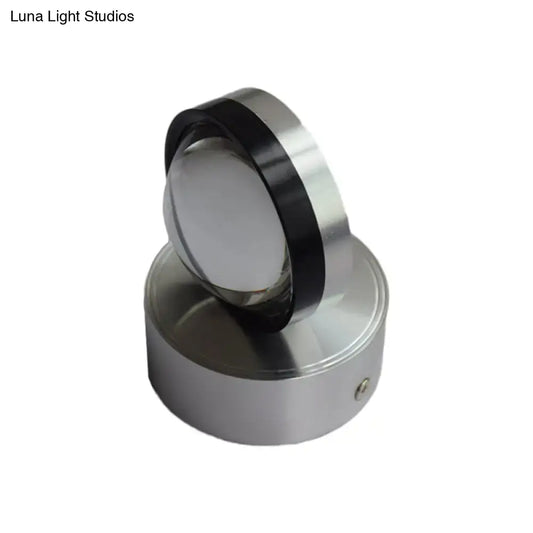Silver finish cylindrical wall-mounted light fixture with polished metallic finish and black accent ring for bedroom wall warm white lighting