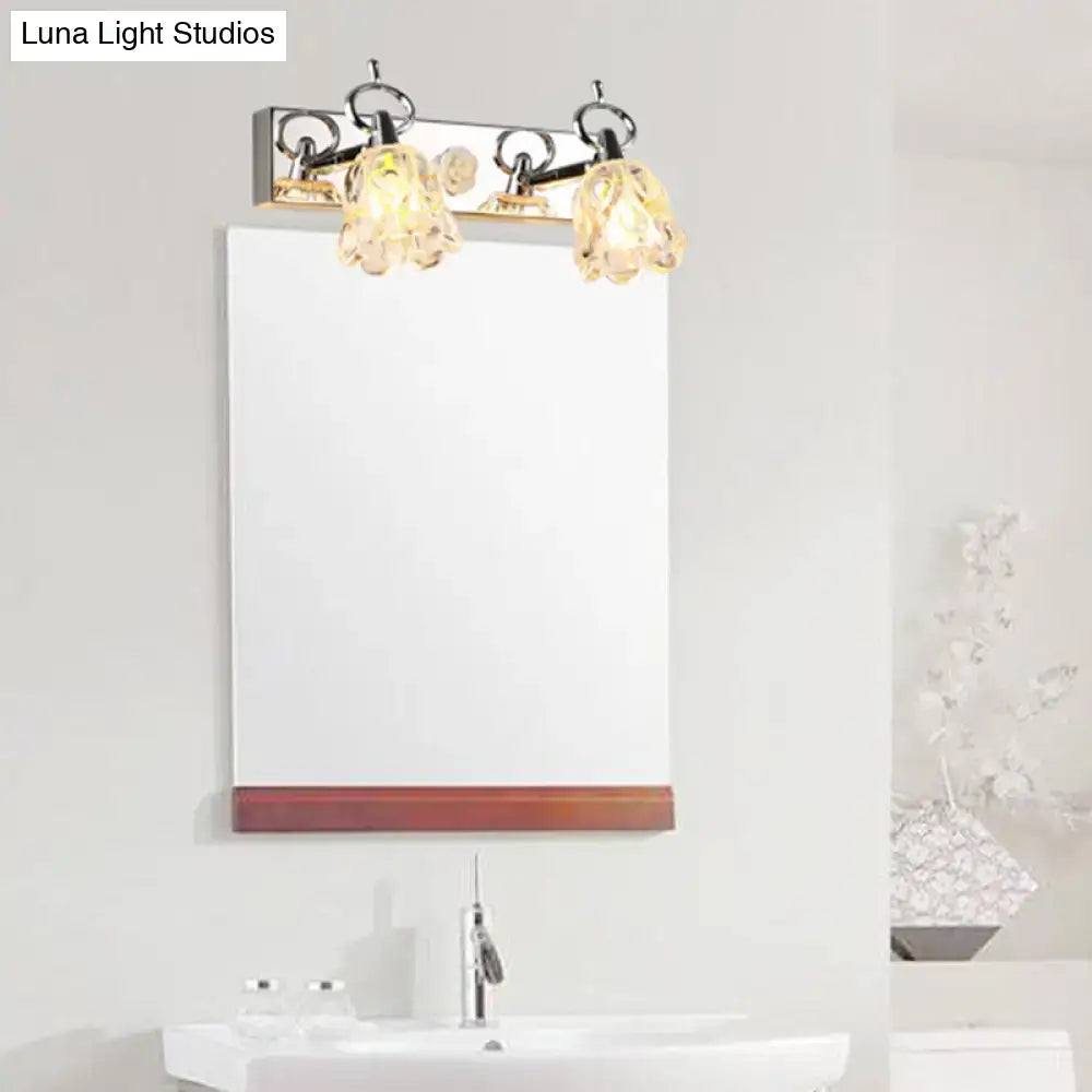 Modern silver finish wall light with three clear glass crystal shades for bathroom vanity illumination