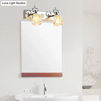 Modern silver finish wall light with three clear glass crystal shades for bathroom vanity illumination
