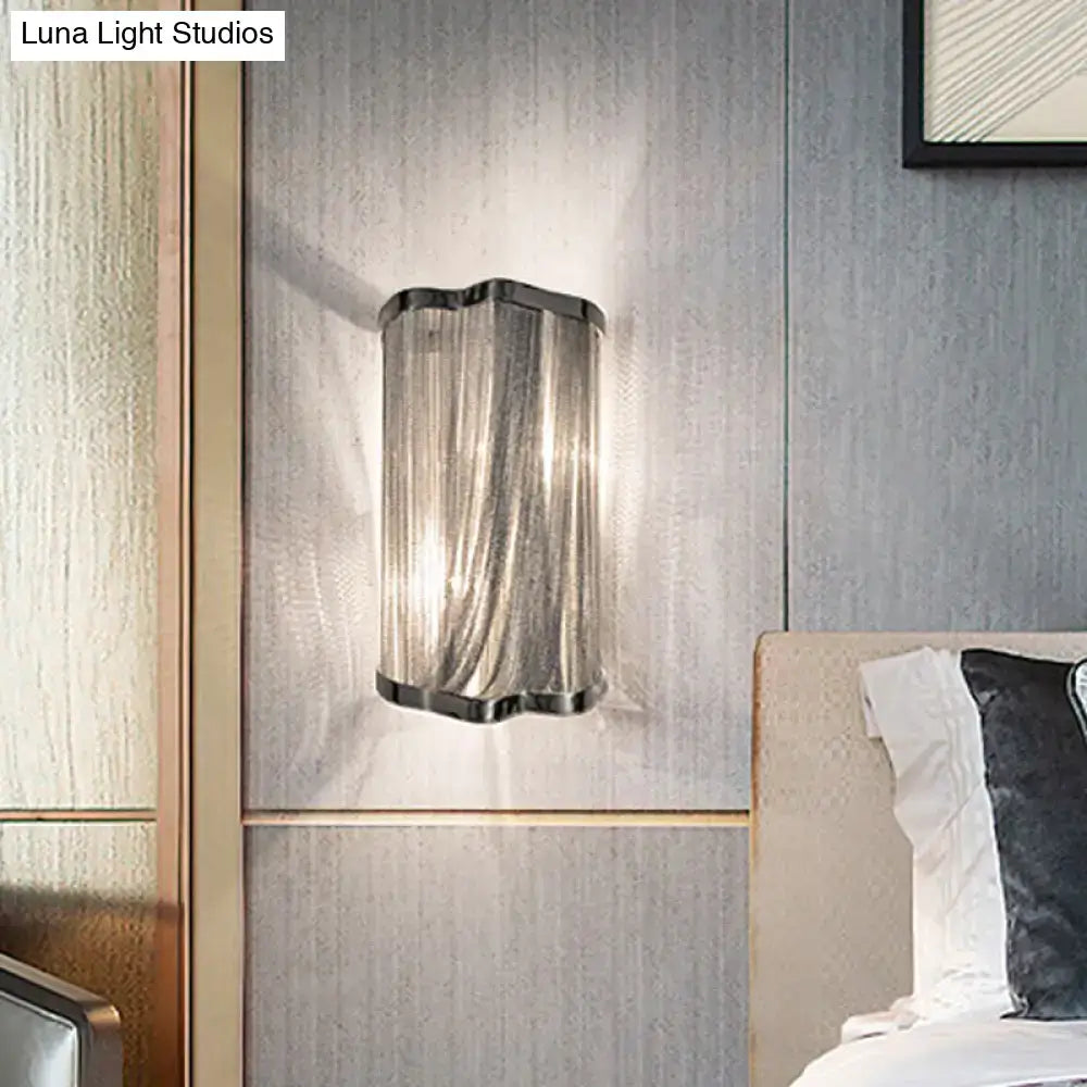 Modern silver finish tassel wall mounted light with sleek curved glass shade and metallic frame for living room wall mounted light