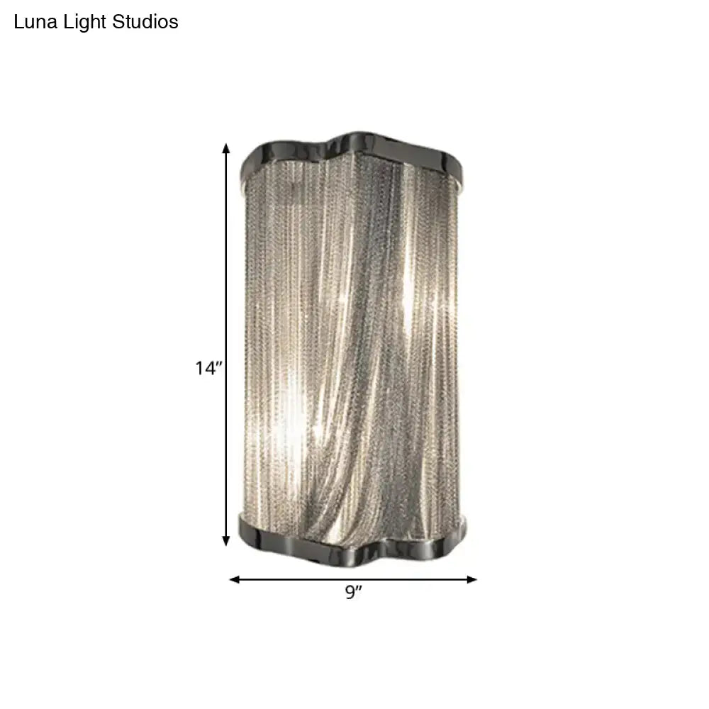 Modern silver finish tassel wall mounted light with cascading metal chains and blackened chrome accents for living room