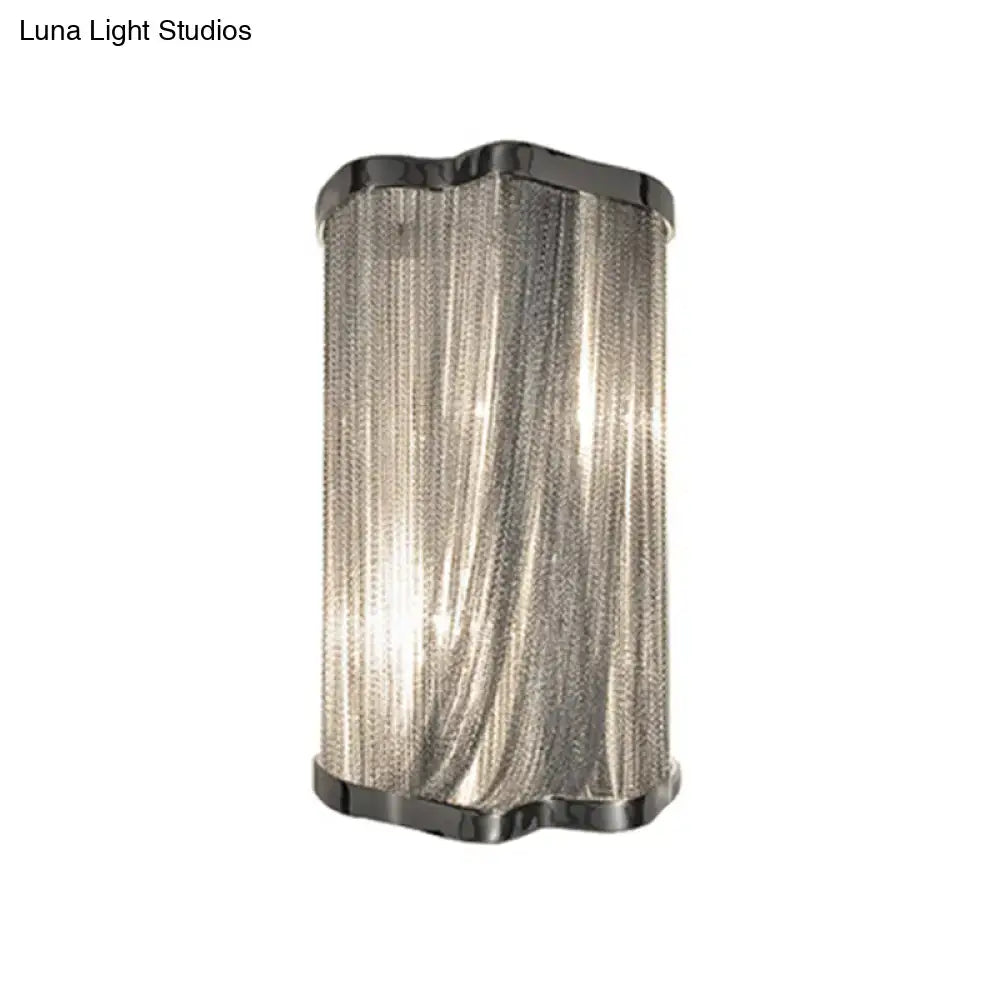Modern silver finish wall mounted light with textured chain curtain and polished black metal frame for living room
