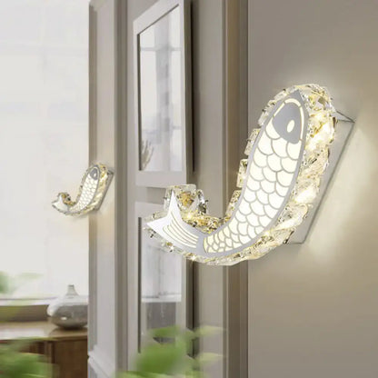 Modern silver fish wall sconce with crystal block shade and silver metallic body for bedroom lighting