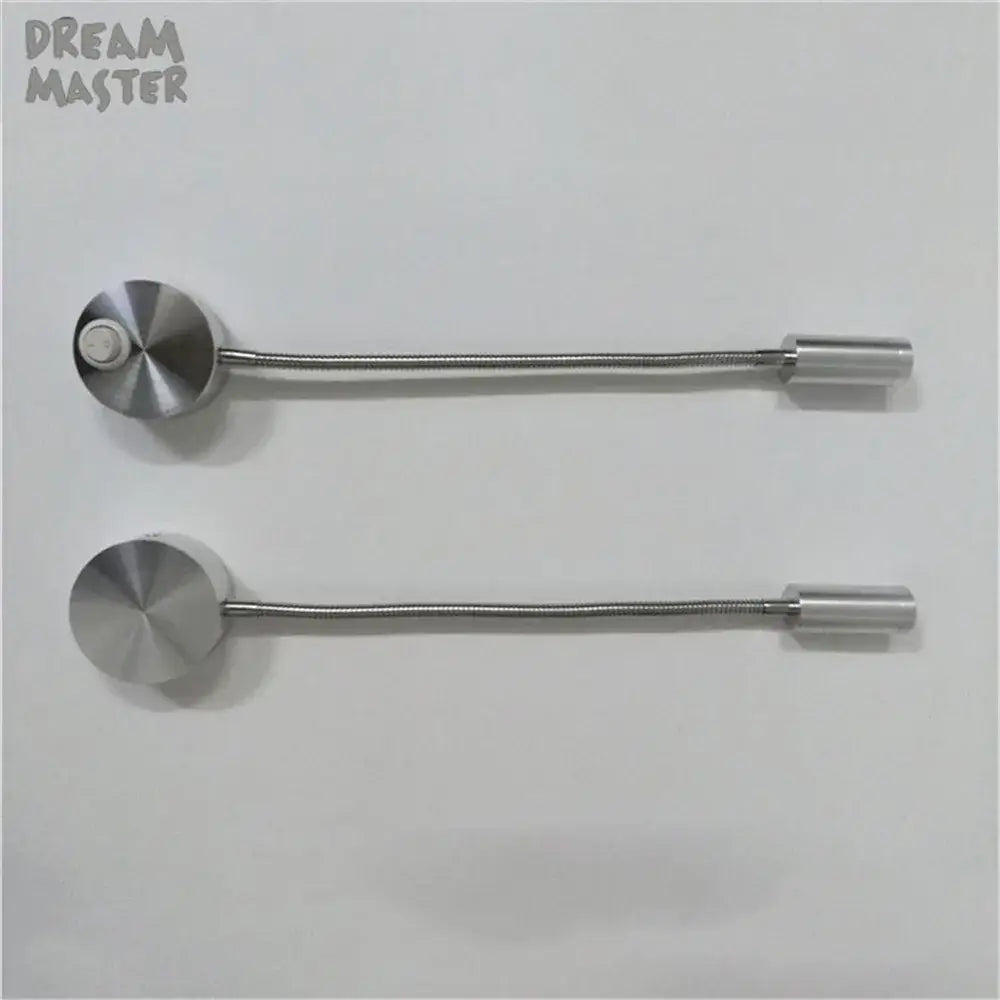 Two sleek silver flexible led wall lamps with circular heads and cylindrical ends for modern bedroom reading