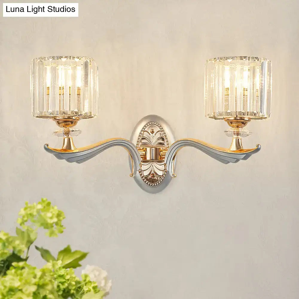 Elegant two-light flush mount wall sconce with clear crystal shade and silver-gold metallic finish for bedroom lighting