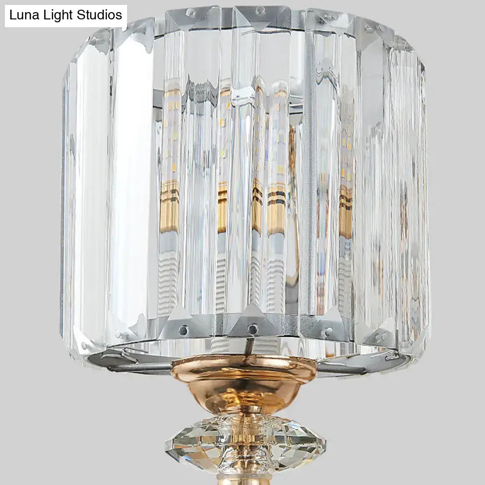Modern silver flush mount wall light with clear crystal shade featuring bulb base and gold-toned metal accents