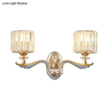 Elegant two-light flush mount wall sconce with gold-toned ornate metal frame and clear crystal shade for bedroom bulb base