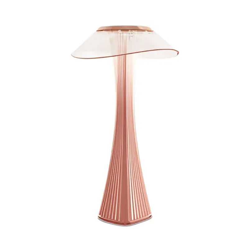 A sleek rose gold table lamp with translucent curved glass shade and vertical ridged base from decorbites crystal diamond touch