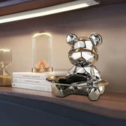 Modern silver geometric bear storage box with shiny metallic finish seated on a matching tray for living room decorbites geometric bear
