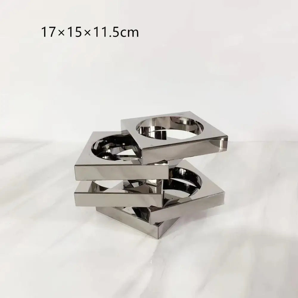 Stacked square metallic cup holder with reflective chrome finish and interlocking design for geometric circle decorbites crystal glass arrangement