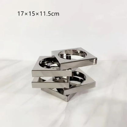 Stacked square metallic cup holder with reflective chrome finish and interlocking design for geometric circle decorbites crystal glass arrangement