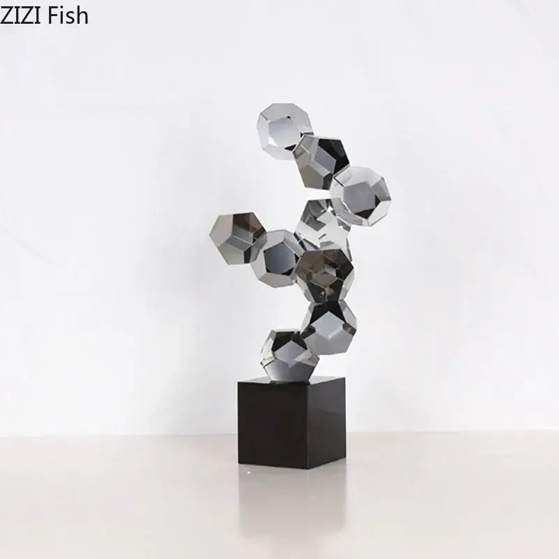Modern silver geometric crystal ball desk ornament featuring interlocking faceted glass orbs on black base