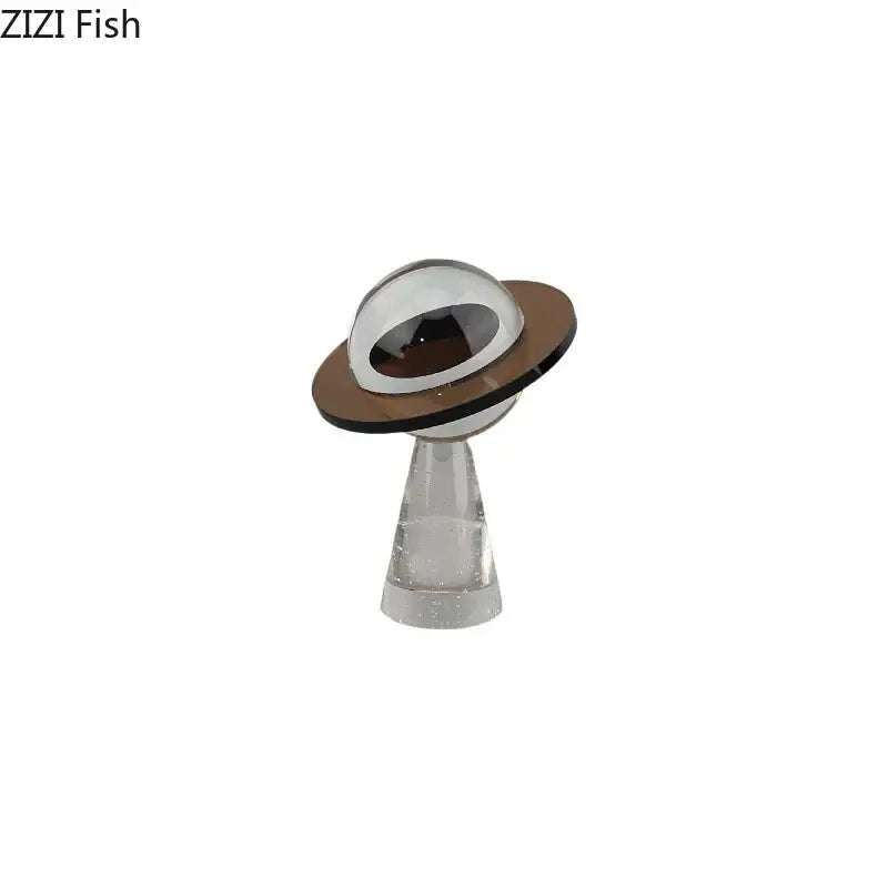 A sleek transparent acrylic desk sculpture with a silver dome and brown ring for modern decorbites geometric crystal star decor