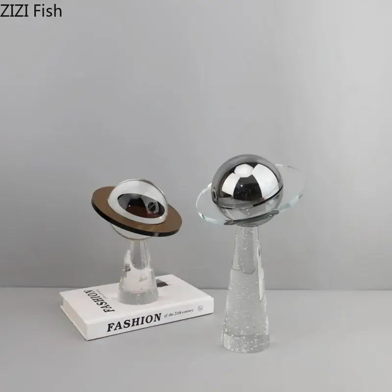 Two sleek modern desk sculptures with silver geometric crystal star design and reflective metallic domes for decorbites decor