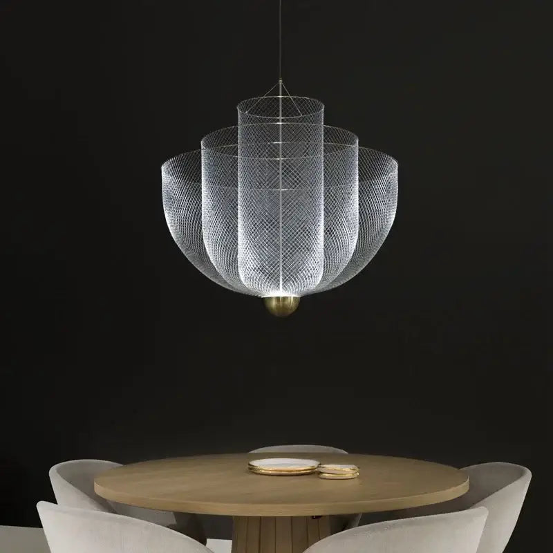 A modern silver geometric iron chandelier with tiered mesh design and brass base hangs above wooden dining table
