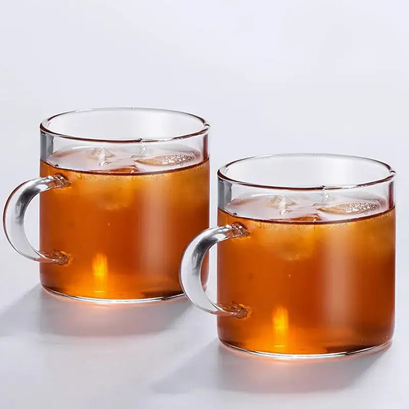 Two clear glass iced tea mugs with modern silver-toned glass handle coffee in a dining room coffee cup set