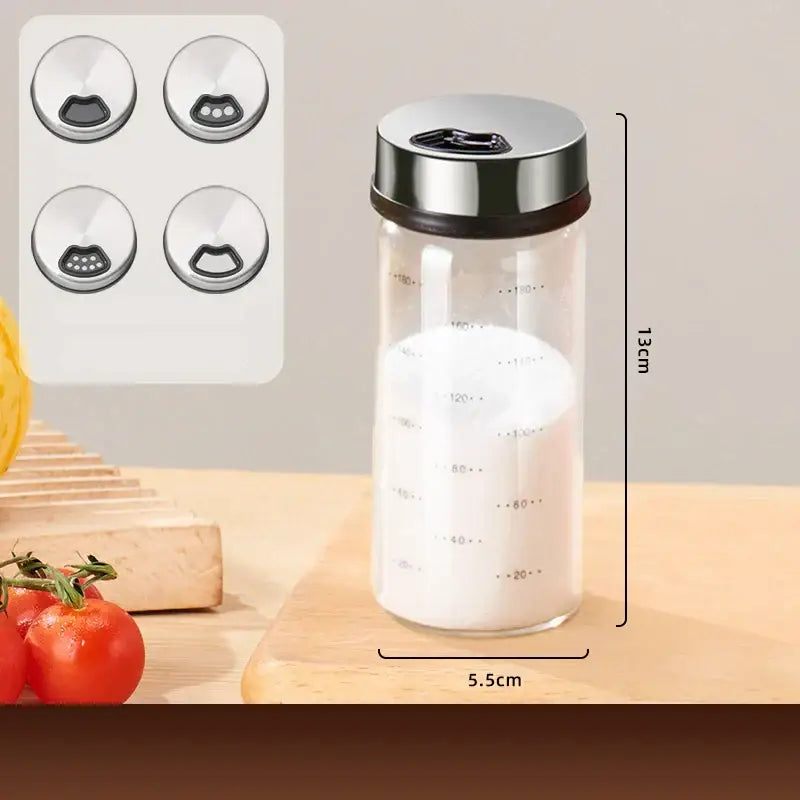 Modern silver glass seasoning jar set featuring a transparent glass seasoning jar with metallic lid and measurement markings