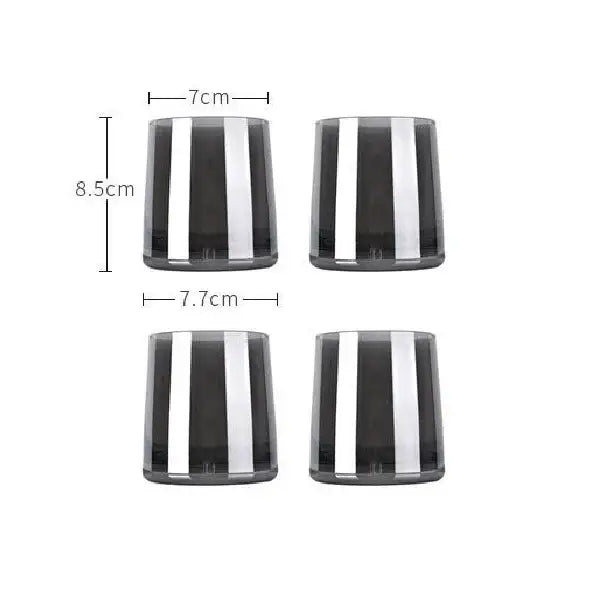Set of four sleek dark gray glass tumblers with bold silver stripes for use with modern glass water pitcher