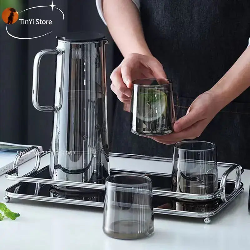Modern silver glass water pitcher made of stainless steel with sleek design and black lid for kitchen use