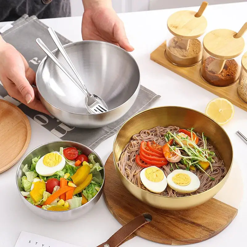 Shiny silver and gold stainless steel mixing bowls with sleek modern design and matching decorbites stainless steel utensils