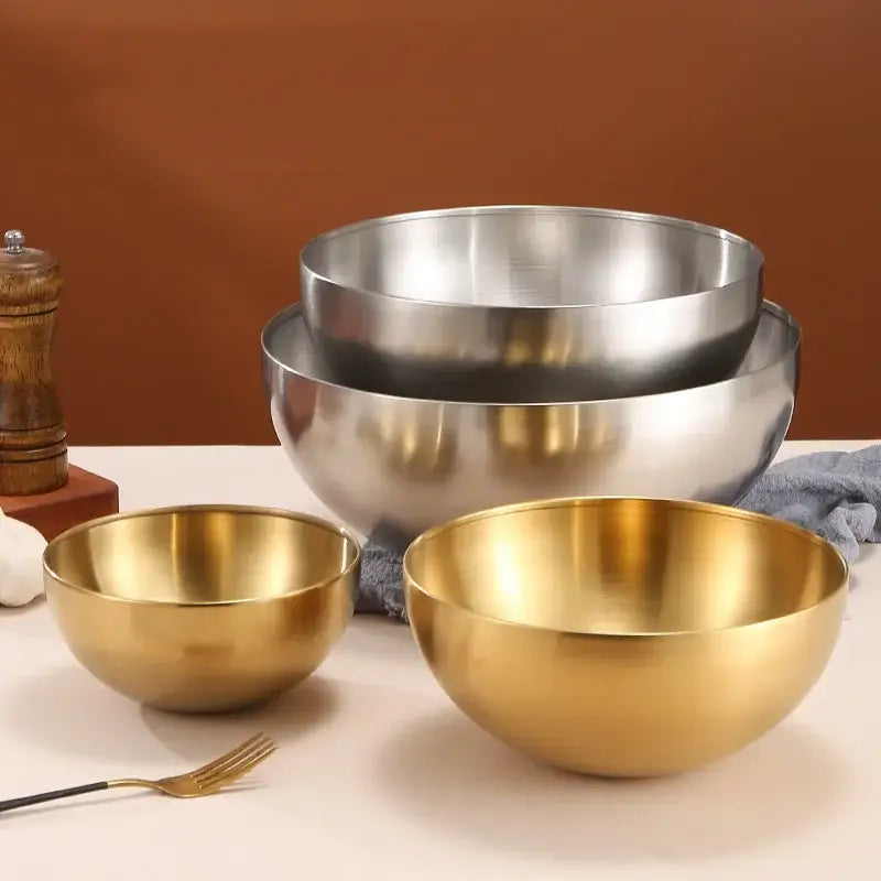 Set of three nested stainless steel mixing bowls with brushed metallic finish in polished silver and matte gold by DecorBites