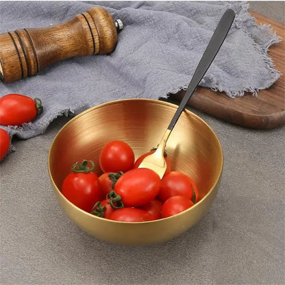 Gold-toned stainless steel mixing bowl from decorbites kitchen set filled with cherry tomatoes and matching spoon