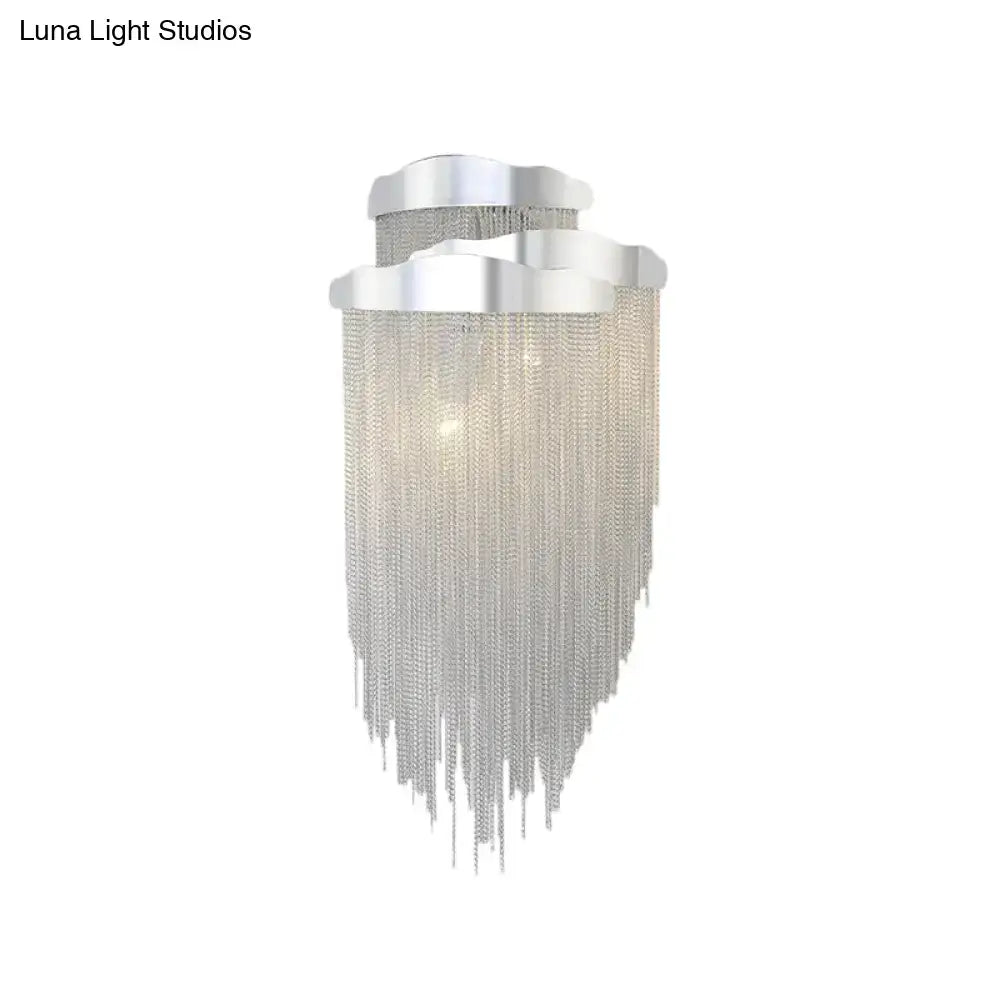 Modern silver tassel design wall lamp with cascading chain fringe and bulb base for bedroom lighting