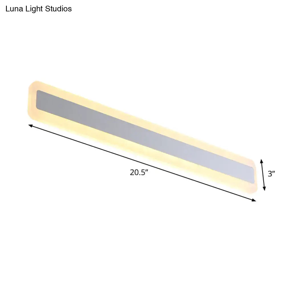 Modern silver led wall light with elongated metal shade features a 20.5-inch slim led light with warm yellow glow
