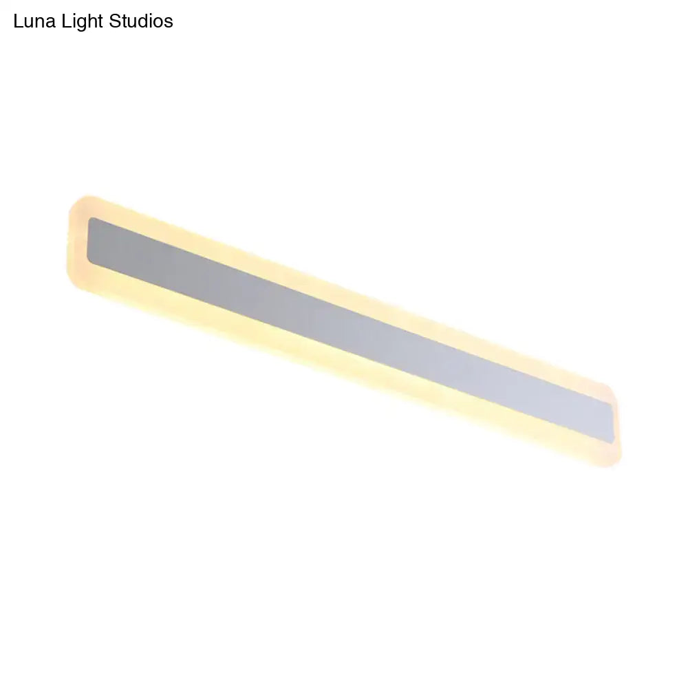 Modern silver led wall light with elongated metal shade features a sleek matte gray panel and warm yellow led light glow