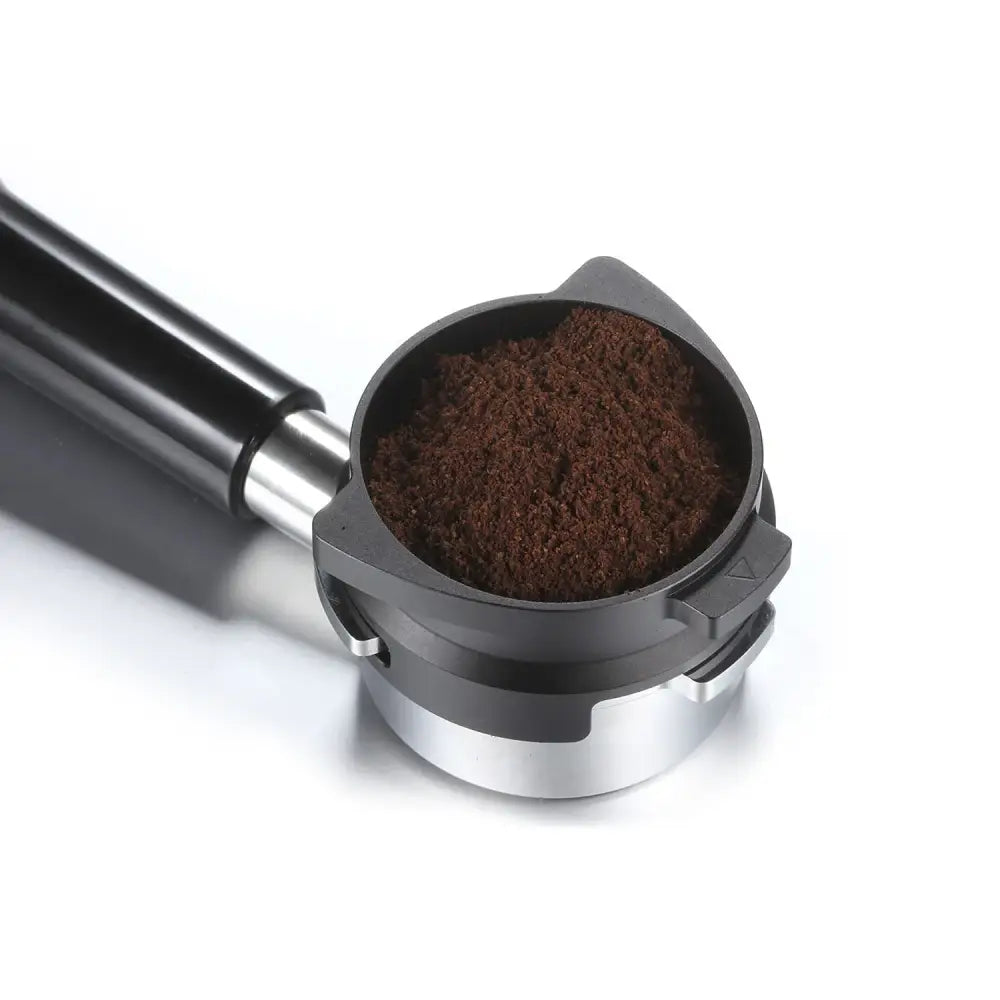 Modern silver machined dosing funnel ring with black and silver espresso portafilter filled with dark brown ground coffee