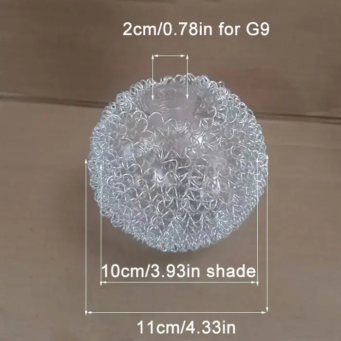 A clear, spherical stress ball with a textured, interwoven metallic mesh surface.