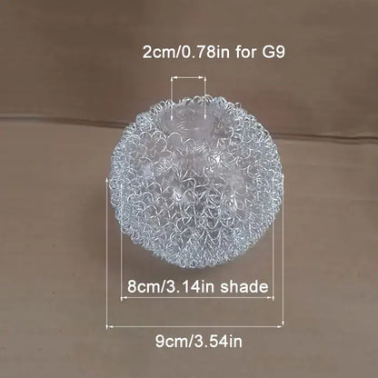 Silver metallic mesh ball with intricate, interwoven circular patterns.